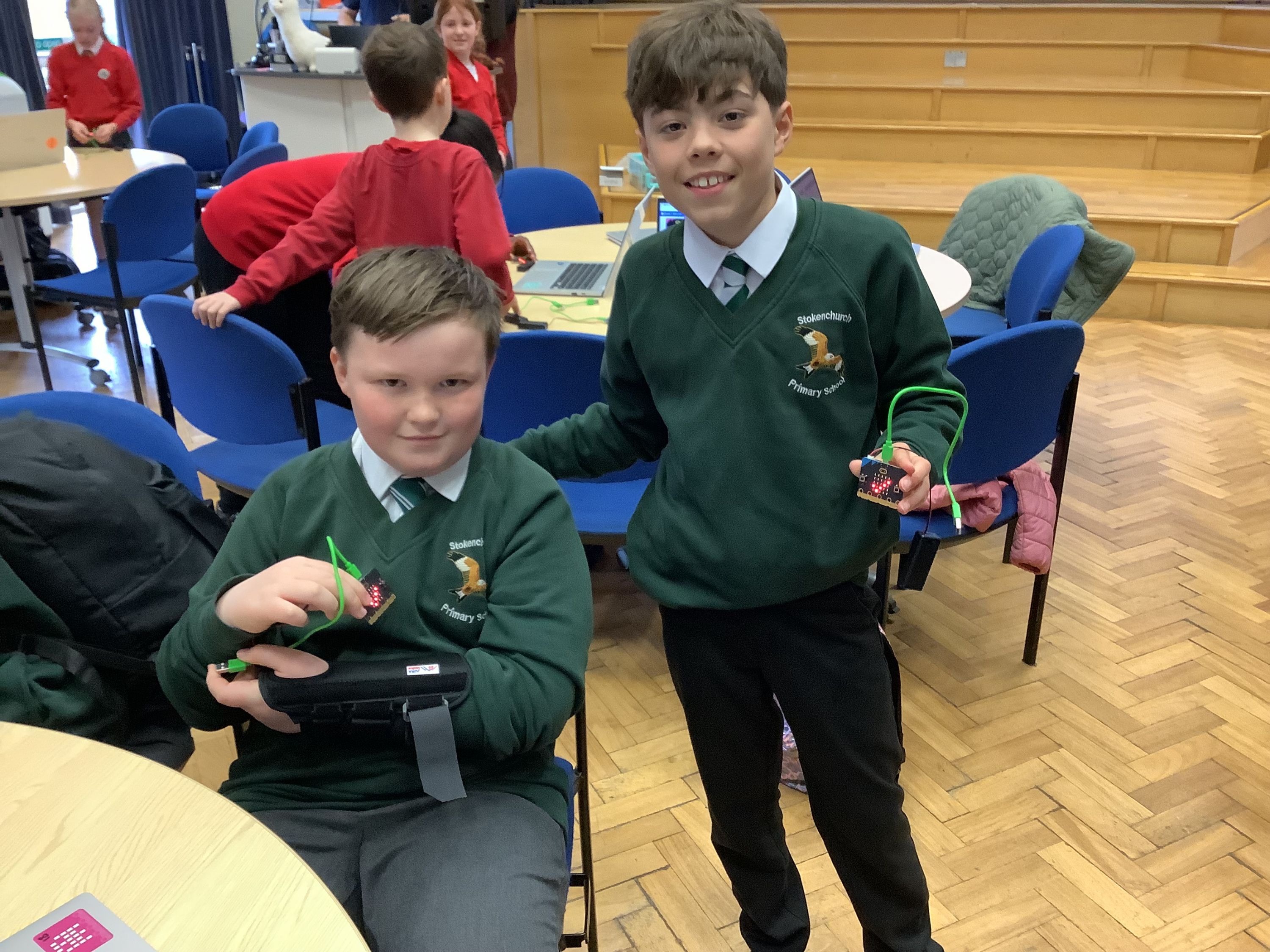2 children demonstrating a micro:bit