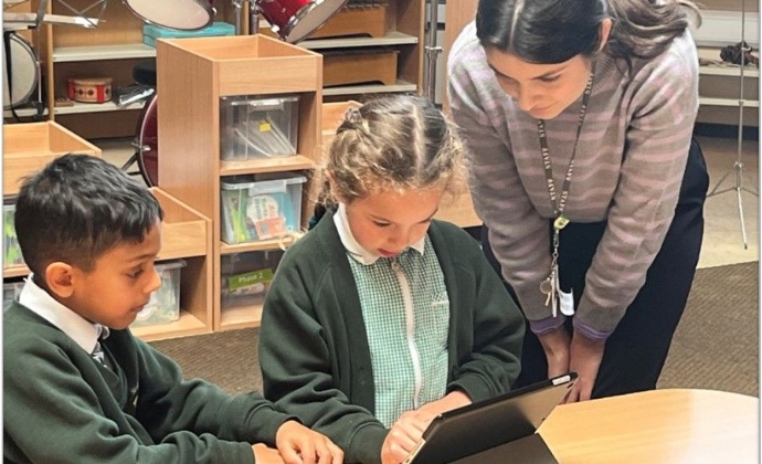 Children using an iPad to create a cartoon
